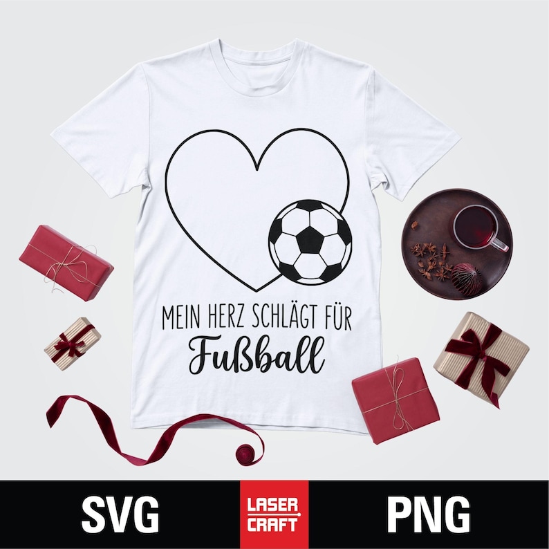 May include: White t-shirt with a black heart and soccer ball graphic. Text reads "MEIN HERZ SCHL&Auml;GT F&Uuml;R Fu&szlig;ball". The shirt is surrounded by wrapped gifts and a decorative plate. SVG and PNG file formats are displayed.