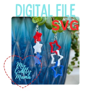 May include: Red, white, and blue star-shaped earrings. The stars are layered on top of each other. The earrings are hanging from a silver hook.