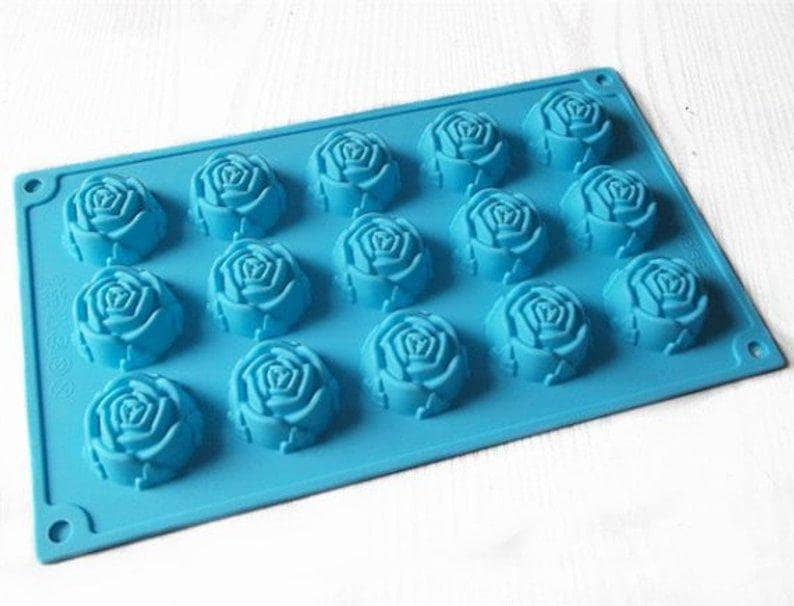 May include: A blue silicone baking mold with 15 rose-shaped cavities. The mold is designed for making small cakes, chocolates, or other treats.