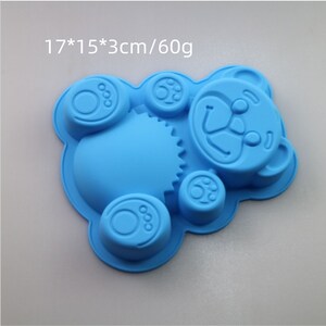 May include: Blue silicone mold shaped like a teddy bear with paw prints. The mold measures 17*15*3cm/60g.