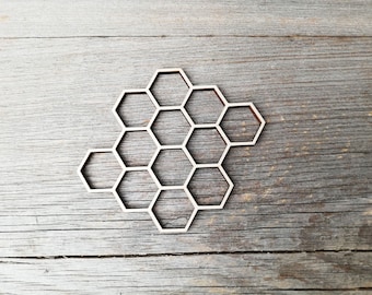 May include: A wooden honeycomb design with a light brown color. The honeycomb is made of individual hexagons that are connected together.