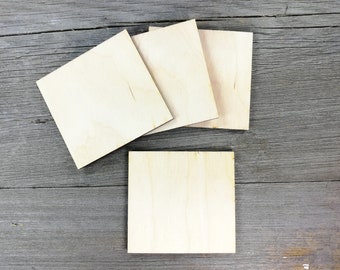 May include: Five unfinished square wooden plaques, perfect for crafting and DIY projects. The plaques are made of light-colored wood and have a smooth surface.