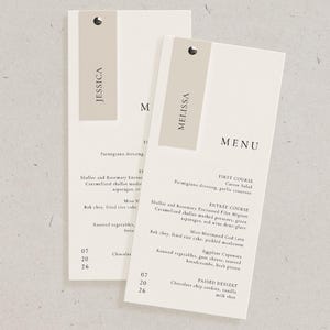 May include: Two rectangular menu cards with the names "JESSICA" and "MELISSA" printed on them. The menus have a neutral color scheme with a light beige background and a darker beige accent. The word "MENU" is visible.