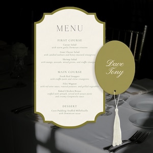 May include: A cream-coloured menu card with a gold border and scalloped edges, featuring the text MENU, FIRST COURSE, MAIN COURSE, and DESSERT. An oval olive-green tag with the white text Dave Tony is attached with a white tassel string.