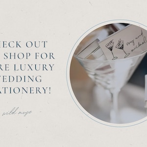 May include: A martini glass with wedding stationery, including a card with cocktail illustrations and the names "rong and michael." The image also includes the text "CHECK OUT THE SHOP FOR MORE LUXURY WEDDING STATIONERY!"