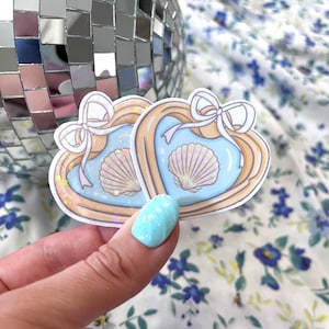 May include: A set of three ceramic vases in varying sizes. The vases have a matte finish in shades of cream, beige, and brown. The tallest vase is approximately 10 inches tall.