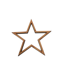May include: A wooden star-shaped cutout with a natural brown finish. The star has five points and a hollow centre. The cutout is likely used for crafts, decorations, or embellishments. The star is set against a white background.