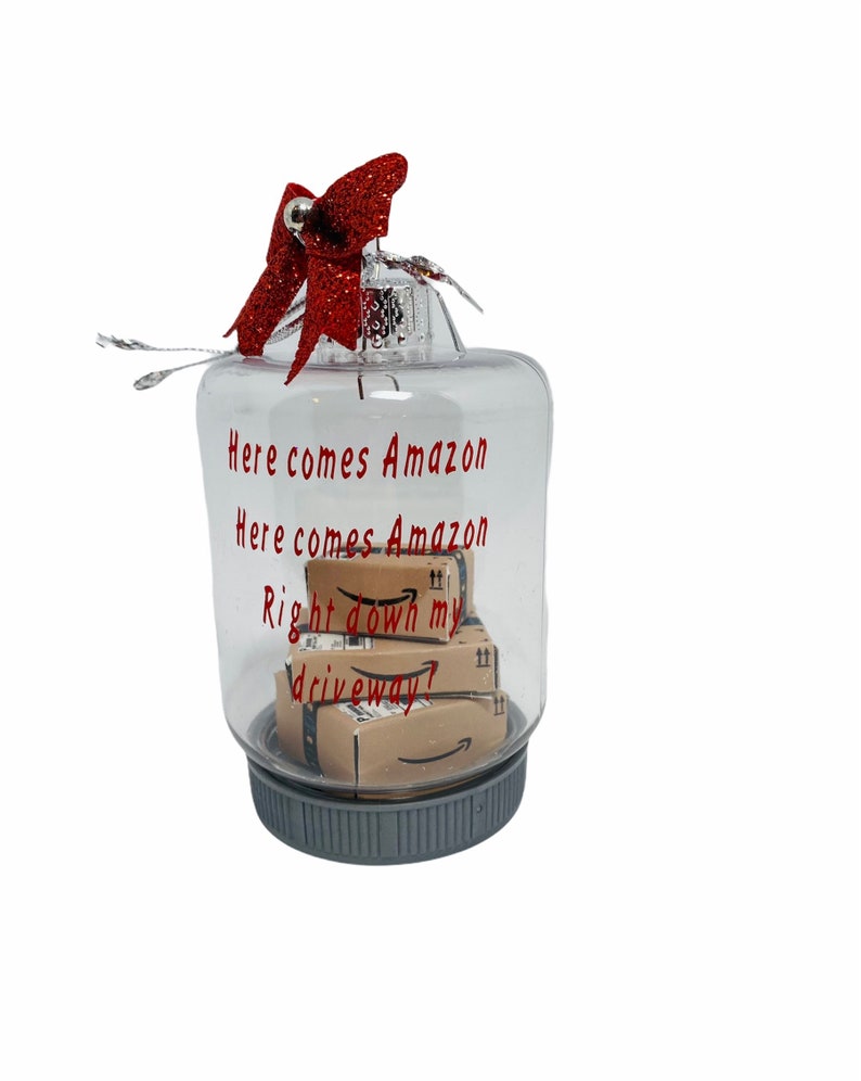 Ornament with Amazon boxes inside that says Here comes