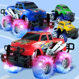 May include: Four toy monster trucks with flashing lights. The trucks are red, blue, green, and yellow. Each truck has a black grill and large wheels. The trucks are all facing the same direction.