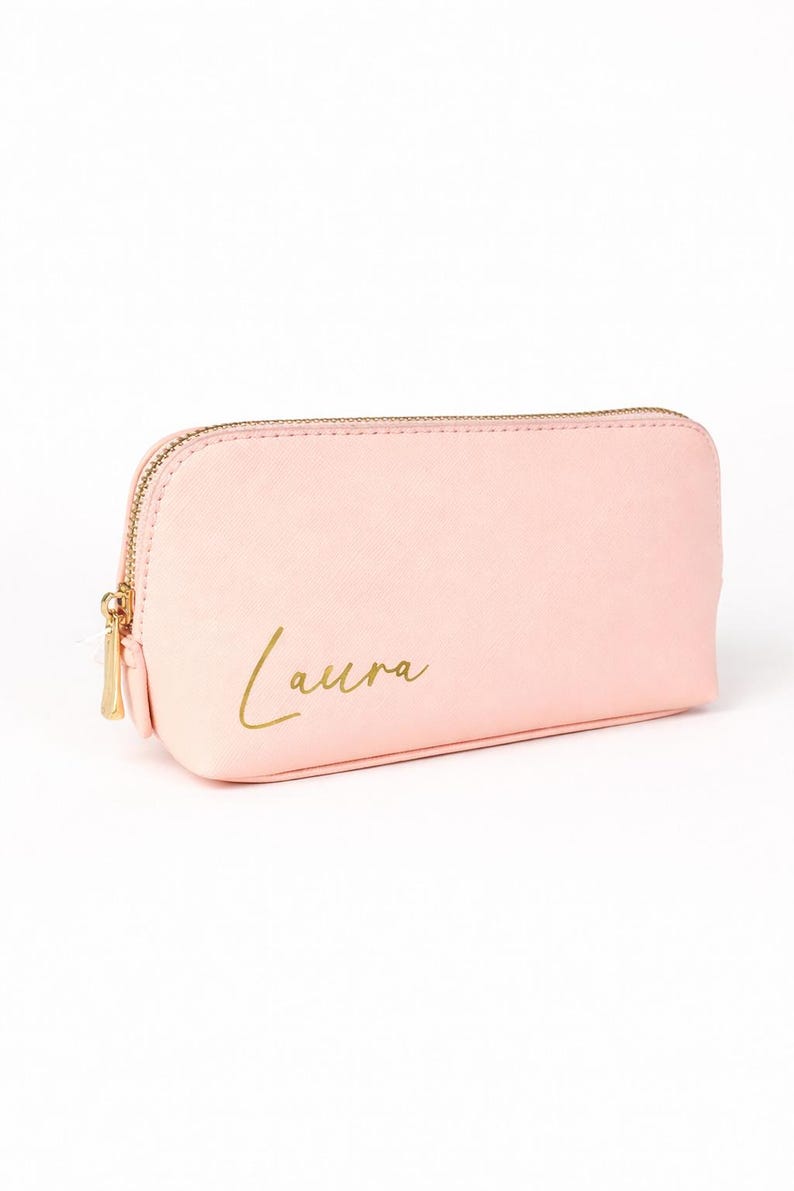 Personalisierte Kosmetiktasche in Rosa mit Name Laura in Goldschrift auf hellem, neutralem Hintergrund