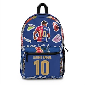 May include: Blue backpack with the name "Lamine Yamal 10" in gold, featuring a soccer player. The bag has a black handle and a front zip pocket. It's decorated with soccer graphics and a player image.
