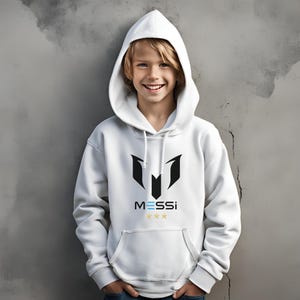 May include: White hooded sweatshirt with a black and white logo that says "MESSI" with three gold stars below the text.