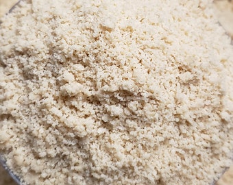 May include: Close-up of a bowl of finely ground, light beige almond flour.