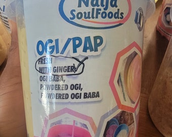 May include: A white plastic container with a blue lid, containing a yellow powder. The container has a label that says "Naija SoulFoods" and "OGI/PAP". The label also says "Fresh with Ginger" and lists ingredients: "OGI BABA, POWDERED OGI, FOWDERED OGI BABA".