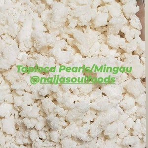 May include: Close-up of white tapioca pearls, also known as Mingau, a popular ingredient in many Asian desserts. The tapioca pearls are small and round, and they have a slightly translucent appearance. Tapioca Pearls/Mingau @naijjasoulfoods