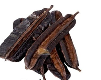 May include: A pile of dried carob pods, a natural sweetener and source of fiber. The pods are dark brown and have a slightly wrinkled texture.
