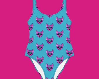 May include: A turquoise swimsuit with a pink and blue pixelated bat pattern.
