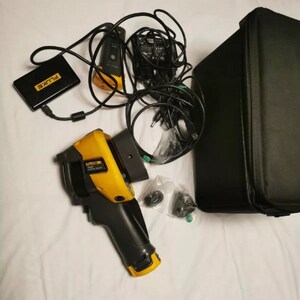 May include: A yellow and black Fluke thermal imaging camera with a black carrying case, a black power adapter, and a black battery pack. The camera has a black handle and a yellow trigger.