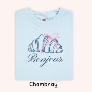 Light Blue T-Shirt with Pink Croissant Graphic, French Bonjour, Cute Casual Wear, Soft Cotton, Unisex