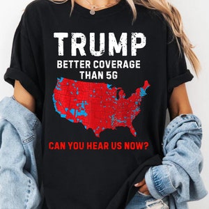 May include: Black t-shirt with a white graphic of a red, white, and blue map of the United States. The text "TRUMP BETTER COVERAGE THAN 5G CAN YOU HEAR US NOW?" is printed on the shirt.
