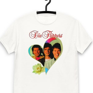 May include: White t-shirt with a heart-shaped image of three men in a band, "Die Flippers", printed on the front.