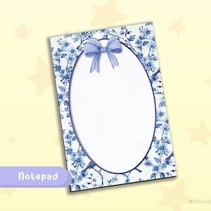 May include: A notepad with a floral design in shades of blue. The notepad has a white oval in the center, a blue bow at the top, and the word "Notepad" in a purple rectangle at the bottom.