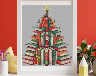 May include: A framed cross-stitch design of a Christmas tree made of books. The tree is composed of stacked books in various colors, with a Santa Claus figure in the center. A gold star tops the tree, and the design is set against a gray background.