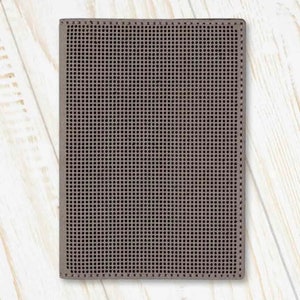 May include: A brown leather wallet with a textured, grid-like pattern.