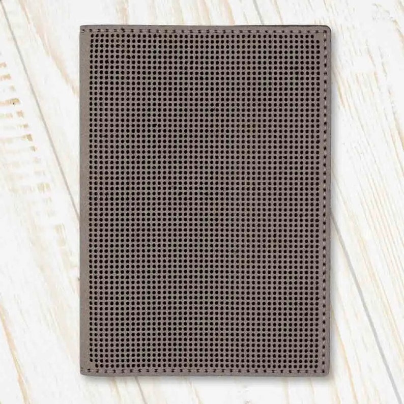 May include: A brown leather wallet with a textured, grid-like pattern.