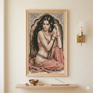 May include: A framed print of a woman in traditional Indian attire. The artwork features a woman in a red and gold sari, adorned with jewelry, set against an ornate background. The frame is light-colored wood.