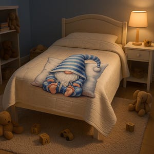 May include: A cozy bedroom scene featuring a bed with a cream-colored quilt and pillow. A whimsical gnome wearing a blue and white striped hat and outfit is on the pillow. A nightstand with a lamp and stuffed animals complete the scene.