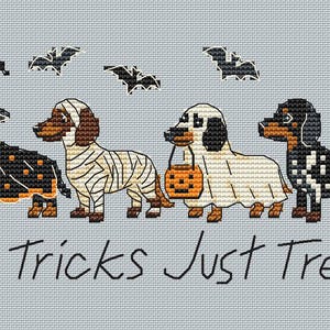 May include: A cross-stitch pattern on light blue fabric featuring four dachshunds in Halloween costumes: a witch, a mummy, a ghost holding a pumpkin bucket, and a skeleton. Above them are four black bats. The text reads: No Tricks Just Treats.