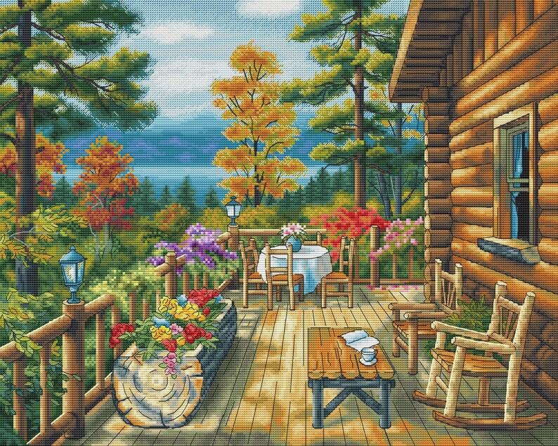 May include: A cross-stitch pattern depicts a cozy cabin porch overlooking a scenic landscape. The porch features a wooden table, chairs, and a flower box filled with colorful blooms. The background showcases a lake, trees, and a vibrant autumn color palette.
