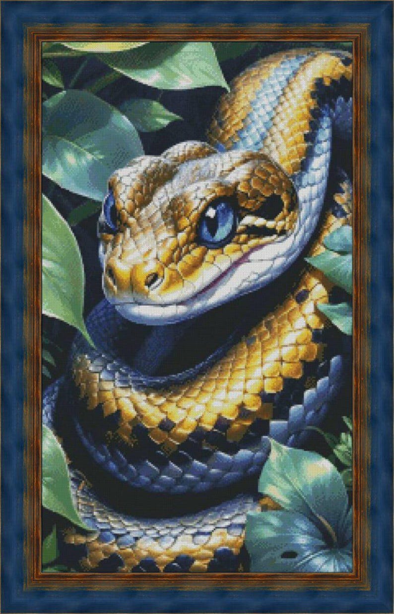 May include: A framed artwork featuring a detailed illustration of a snake. The snake has a golden and black pattern with blue eyes, surrounded by green leaves. The frame is a dark blue color.