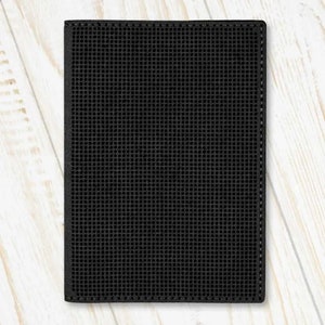May include: Black leather wallet with a textured, grid-like pattern.