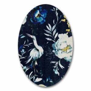 May include: A dark blue fabric with a white bird and blue and white flowers. The fabric has a floral pattern.