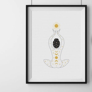 May include: A black and white line drawing of a person sitting in a yoga pose with their arms raised above their head. The person is covered in gold stars, moons, and a sun. The sun is above the person's head.