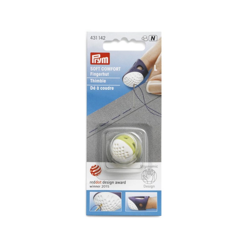 May include: A white and green finger thimble with a textured surface. The thimble is labeled "Soft Comfort Fingerhut Thimble" and "D&eacute; &agrave; coudre". The packaging also includes the text "reddot design award winner 2015" and "Ergonomic Design".