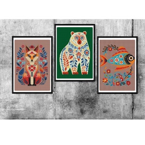 May include: Three framed illustrations of animals with floral patterns. The first image shows a fox with orange and red fur, the second image shows a bear with white fur, and the third image shows a fish with blue and orange scales.