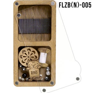 May include: A wooden box with a clear lid containing a variety of sewing supplies, including needles, thread, beads, and a small wooden cat figurine. The box is labeled "FLZB(N)-005".