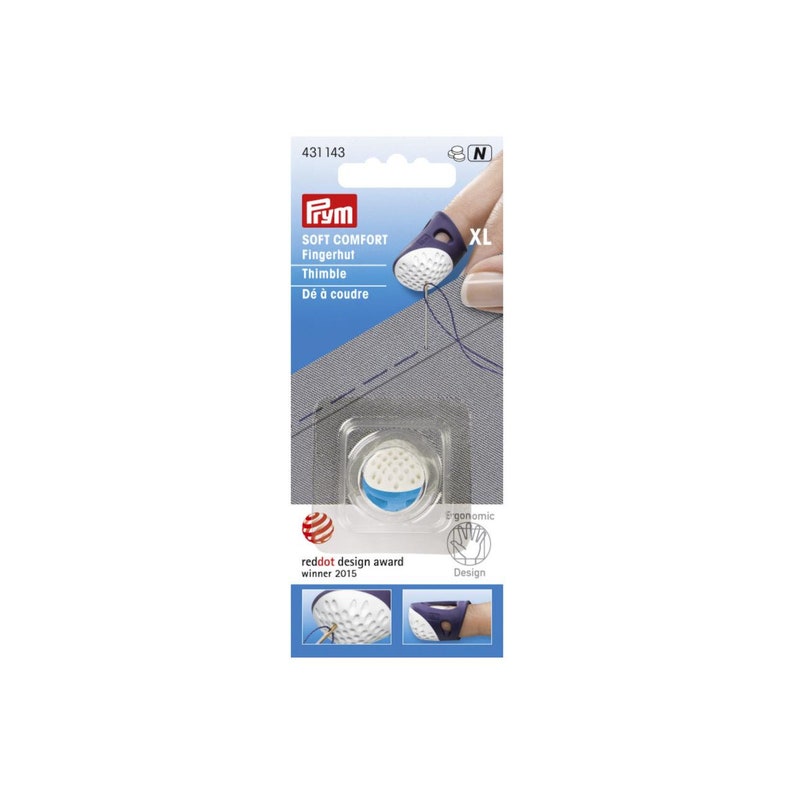 May include: A white and blue finger thimble with a textured surface. The thimble is labeled "Soft Comfort Fingerhut Thimble" and "D&eacute; &agrave; coudre". The thimble is labeled "XL" and is part of the Prym brand. The thimble is shown on a finger and is being used to sew on a gray fabric. The thimble is a reddot design award winner from 2015.