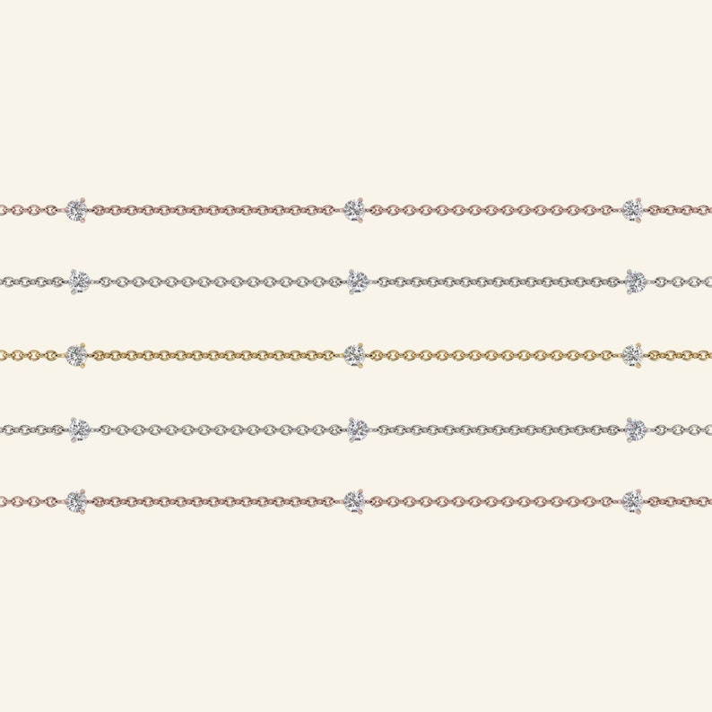 May include: Five delicate necklaces with a simple chain design and two small diamond accents. The necklaces are shown in rose gold, silver, and gold.