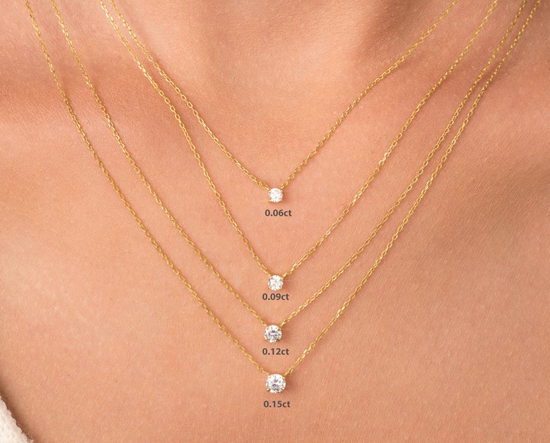 May include: Four gold necklaces with different sized diamond pendants. The pendants are 0.06ct, 0.09ct, 0.12ct, and 0.15ct.
