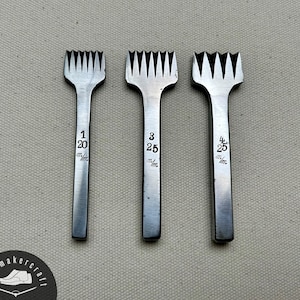 May include: Three metal leather working tools with toothed edges, each with a different number etched on the handle: 1/20, 3/25, and 4/25. The tools are arranged vertically against a neutral background.