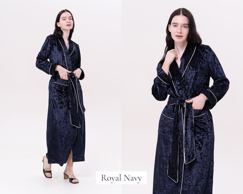 May include: A navy blue velvet robe with white piping. The robe has a shawl collar, a tie belt, and two pockets.