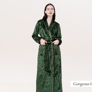 May include: A long, dark green velvet robe with a shawl collar and a self-tie sash. The robe has a subtle shimmer and a slightly textured surface. The text "Gorgeous Green" is visible in the lower right corner of the image.