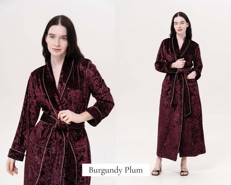 May include: A long, burgundy velvet robe with gold piping. The robe has a shawl collar, a tie belt, and two pockets.