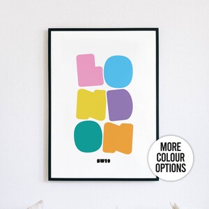 May include: A framed print featuring the word "LONDON" spelled out in colourful, abstract letters. The letters are in pink, blue, yellow, purple, teal, and orange. The print also includes the text "SW19" in black.