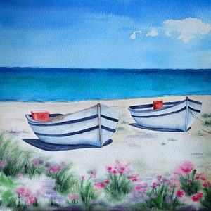May include: Watercolour painting of two white and blue boats on a sandy beach. Each boat has a red rectangular block. The ocean is turquoise and the sky is blue with a single cloud. Pink flowers and green grass are in the foreground.