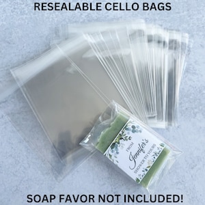 May include: A stack of clear resealable cellophane bags, with a single bag containing a green bar of soap with a white label that reads "From Jennifer's Shower to Yours". The text "SOAP FAVOR NOT INCLUDED!" is printed below the image.